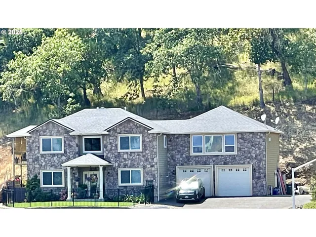 a front view of a residential houses with yard