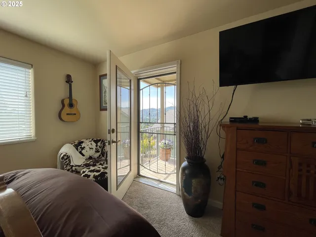 a bedroom with a bed and flat tv screen