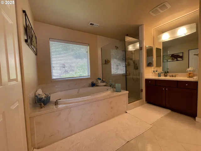 a bathroom with a tub sink and mirror
