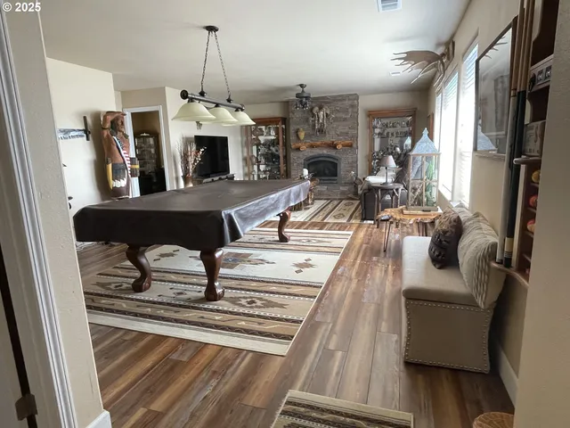 a living room with furniture a fireplace and a chandelier