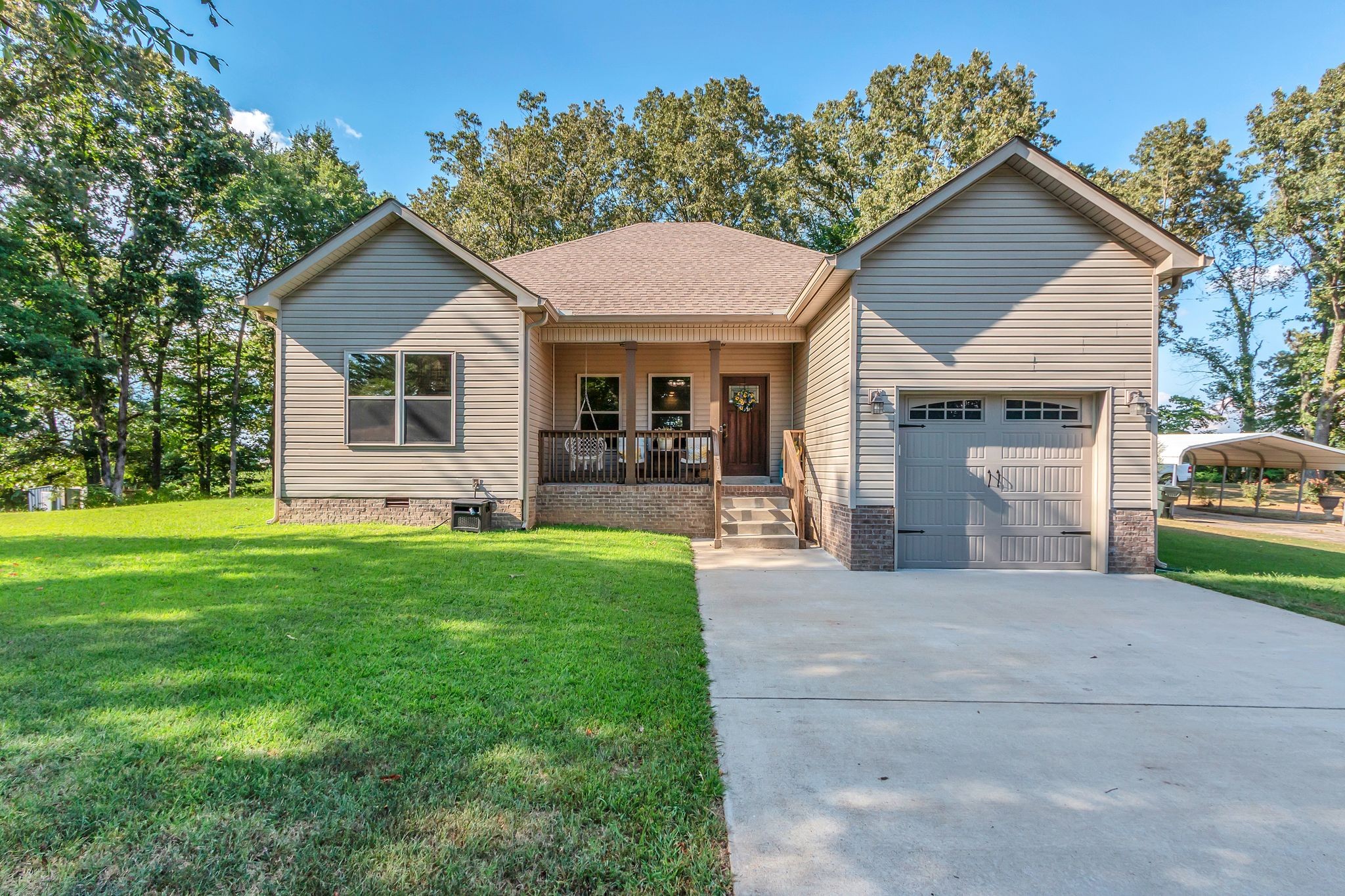 1027 Garton Road Burns, TN 37029 - Photo 1 of 36 a front view of house with yard and green space