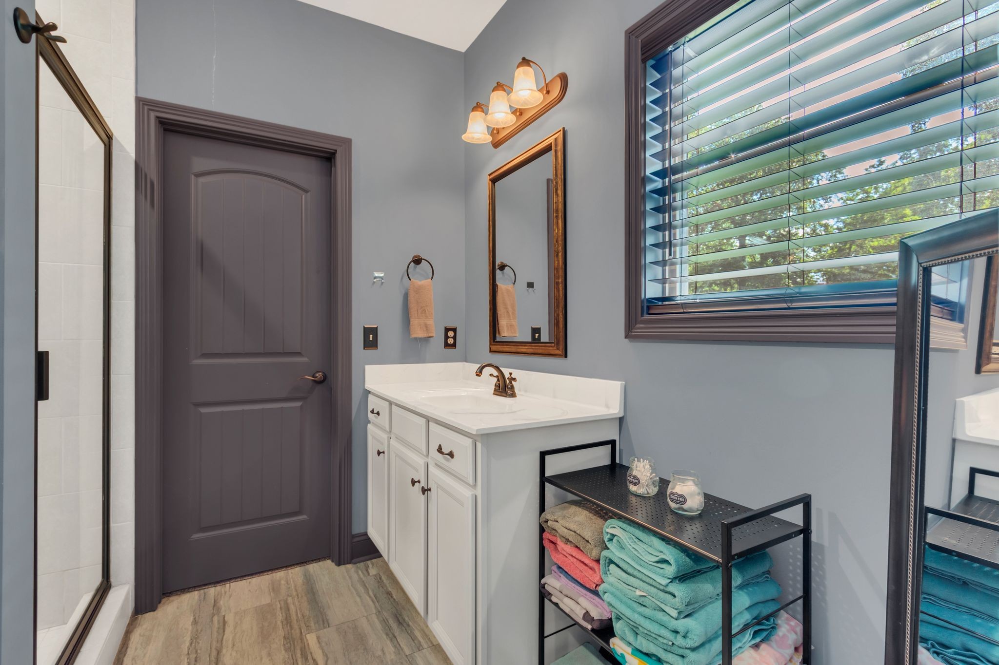 1027 Garton Road Burns, TN 37029 - Photo 19 of 36 a bathroom with a sink a mirror and a shower