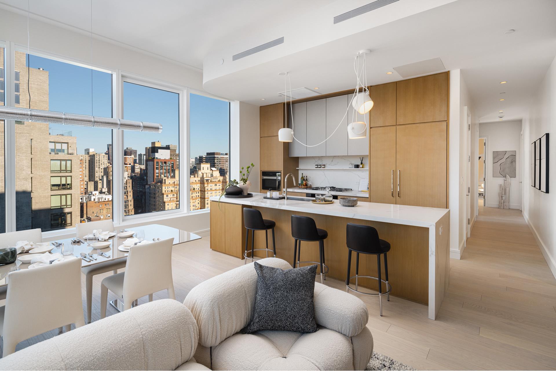 200 East 20th Street, Unit PHA Manhattan, NY 10003 - Photo 2 of 15 a living room with stainless steel appliances kitchen island granite countertop furniture and a kitchen view
