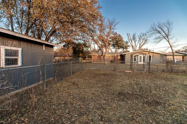 a backyard of a house with large trees