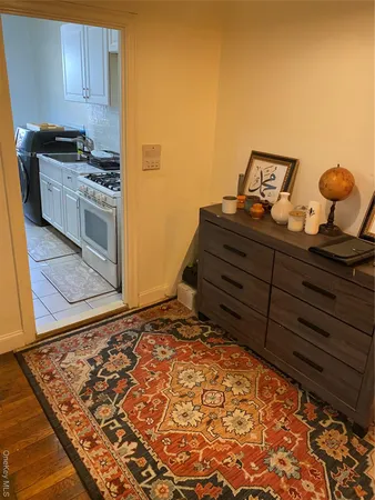 a bed sitting in a bedroom next to a larger window