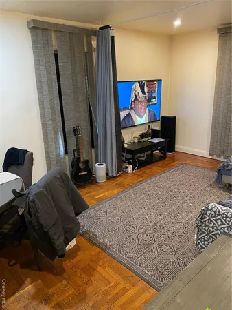 a living room with projector and a flat screen tv