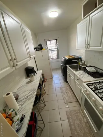 a kitchen with stove and cabinets