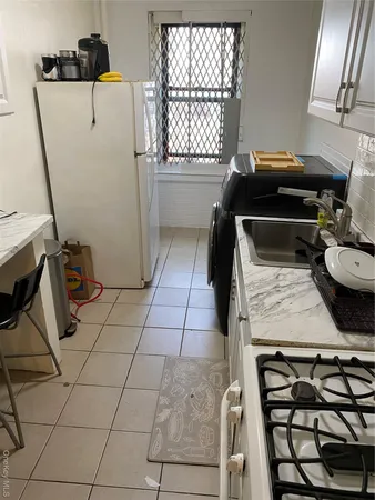 a kitchen with a sink a stove and a window