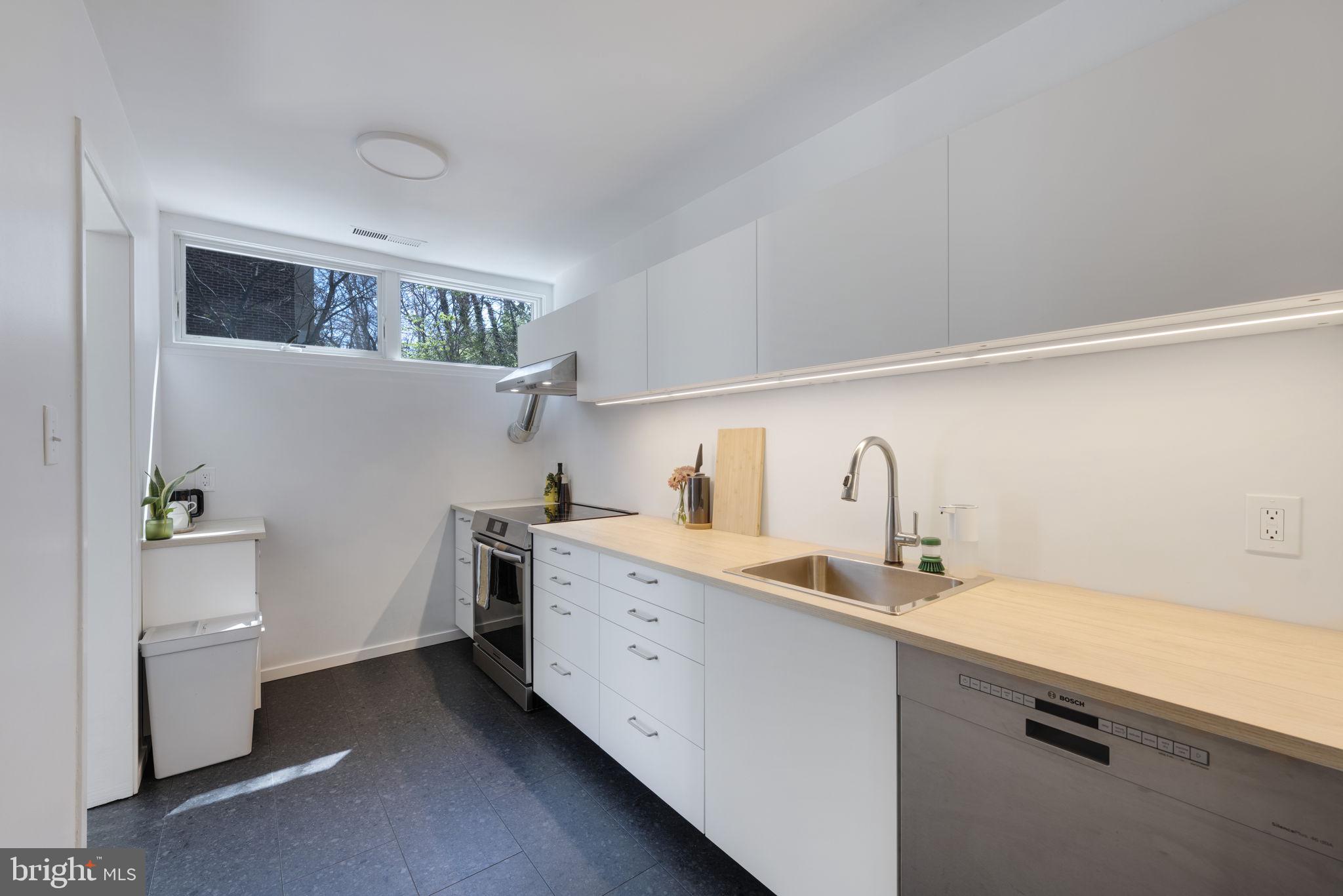11527 Hickory Cluster Reston, VA 20190 - Photo 12 of 30 a kitchen with a sink cabinets and window