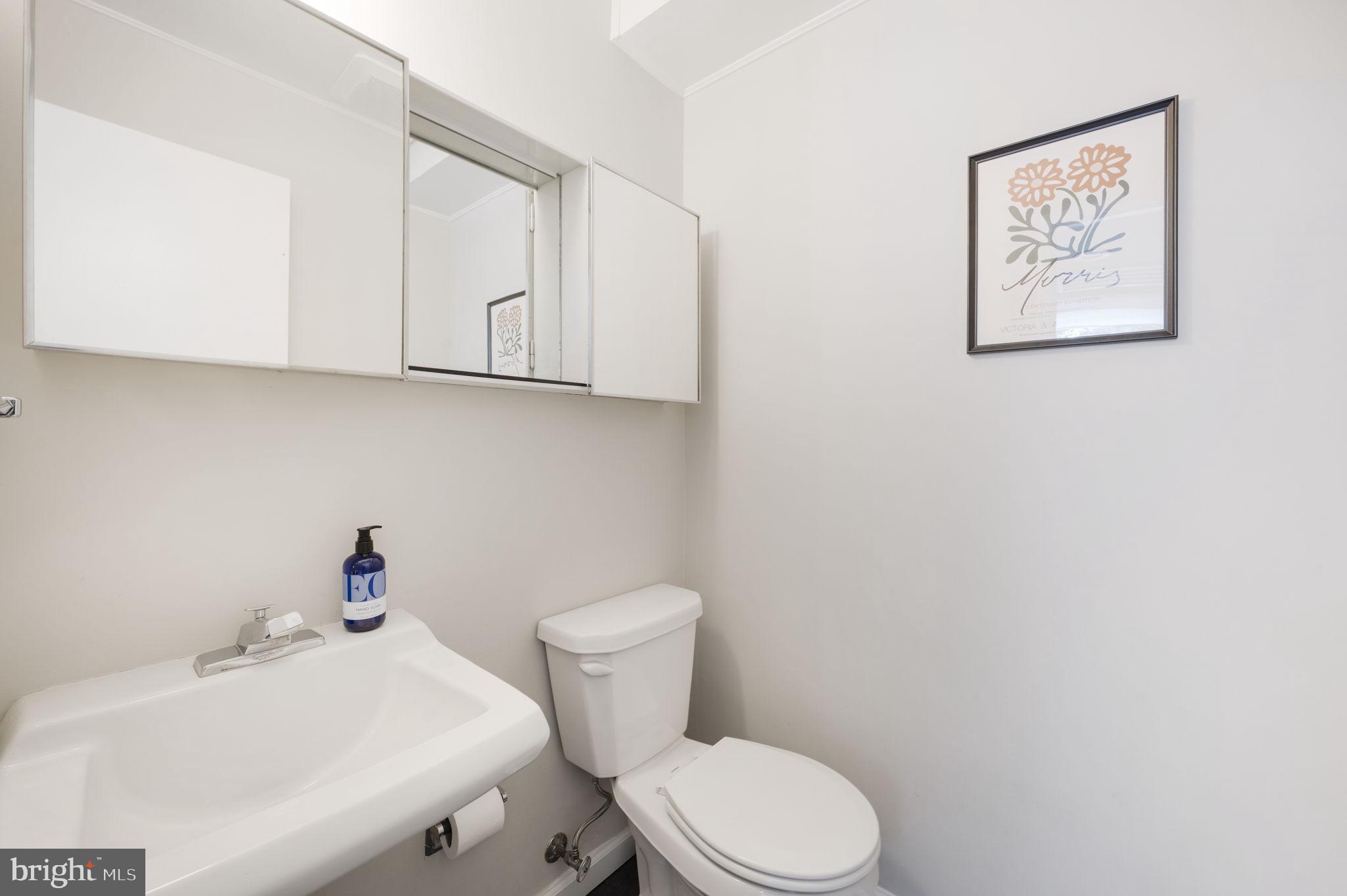 11527 Hickory Cluster Reston, VA 20190 - Photo 14 of 30 a white toilet sitting next to a bathroom sink