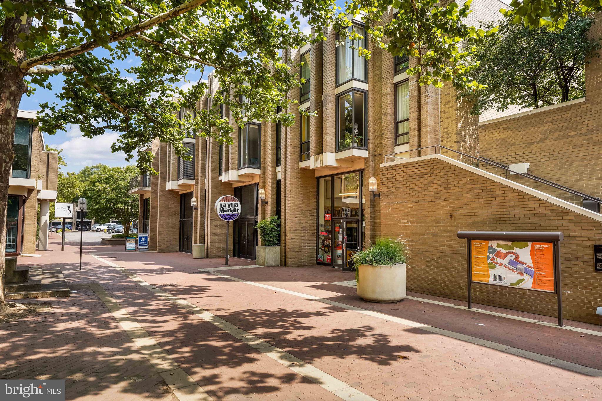 11527 Hickory Cluster Reston, VA 20190 - Photo 27 of 30 a front view of a house with a yard