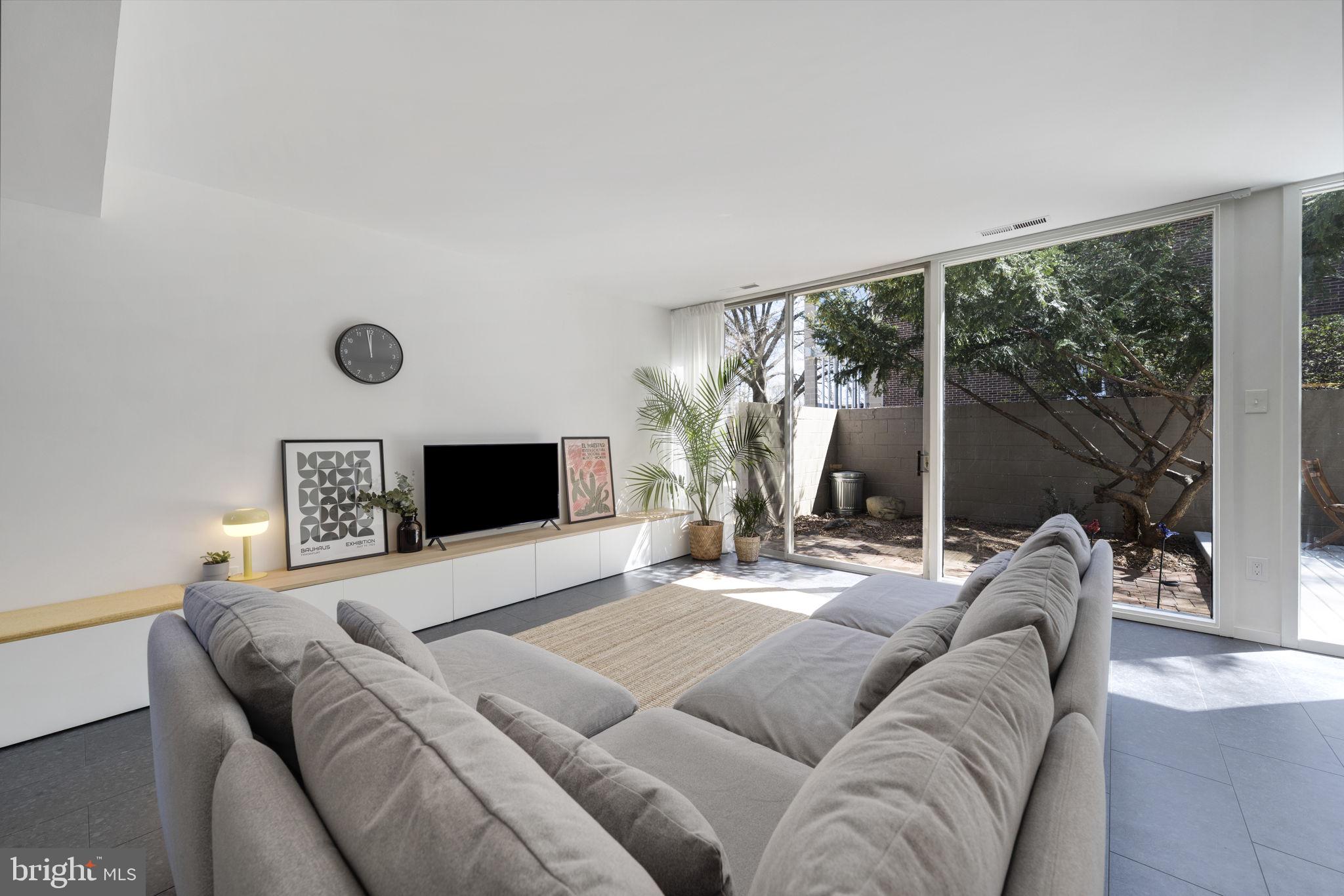 11527 Hickory Cluster Reston, VA 20190 - Photo 8 of 30 a living room with a bed furniture and a large window