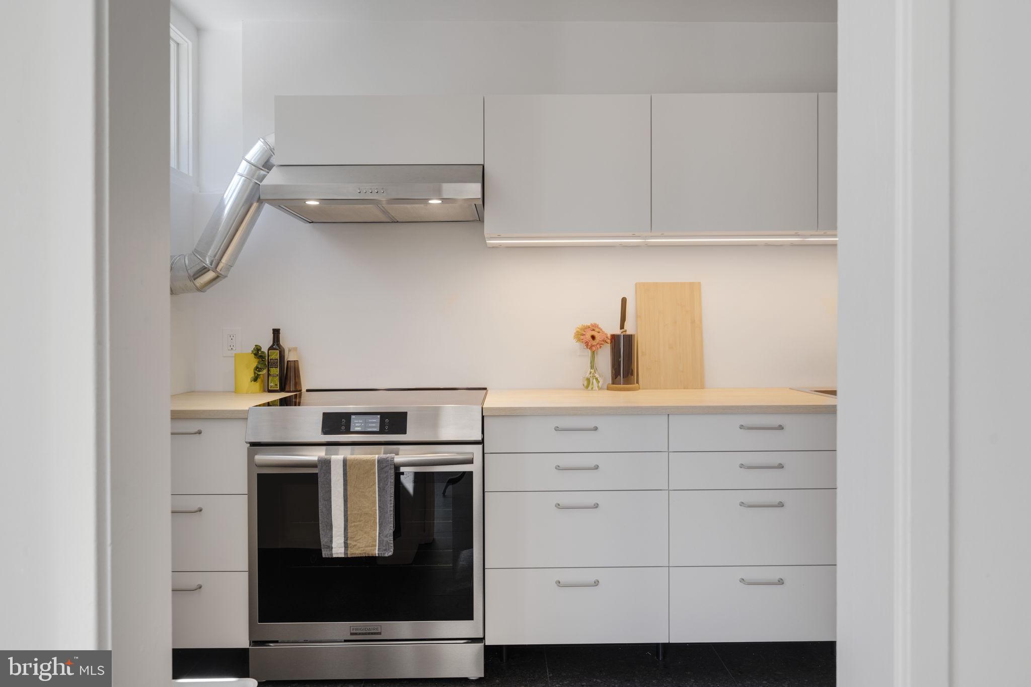 11527 Hickory Cluster Reston, VA 20190 - Photo 10 of 30 a kitchen with white cabinets and white appliances