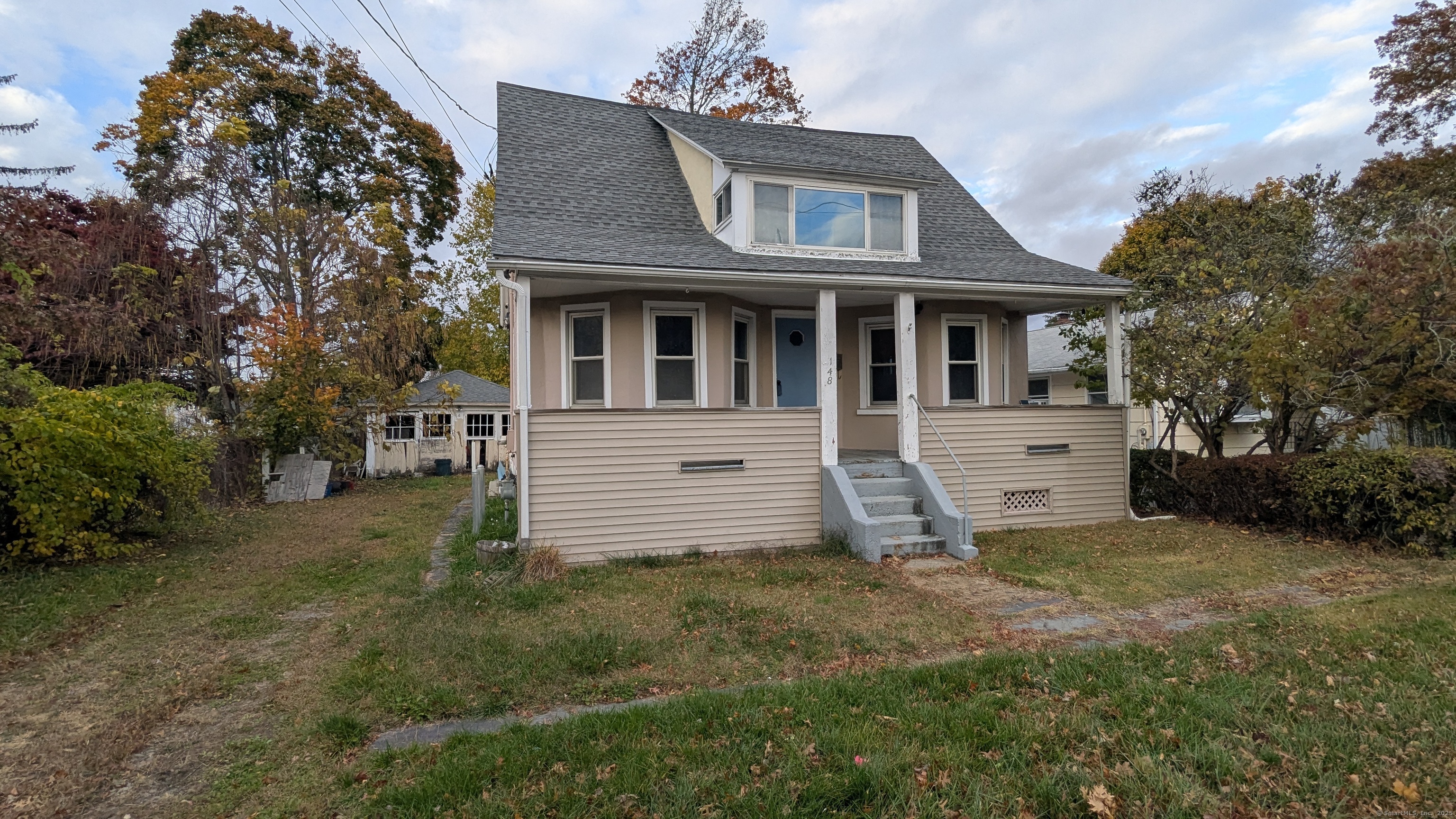 Undisclosed Address Fairfield, CT 06825 - Photo 1 of 14 a front view of a house with a yard