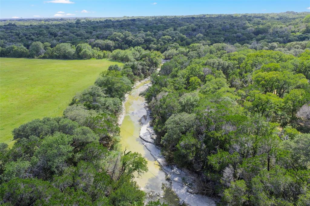 1044 Audrey Avenue Waco, TX 76705 - Photo 10 of 16 an aerial view of green landscape with trees houses and mountain view