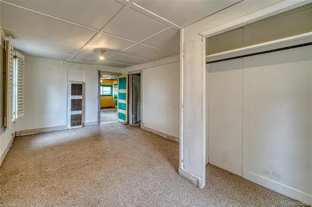 a utility room with cabinets and refrigerator