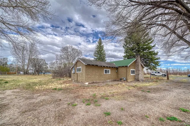 a front view of house with yard and trees