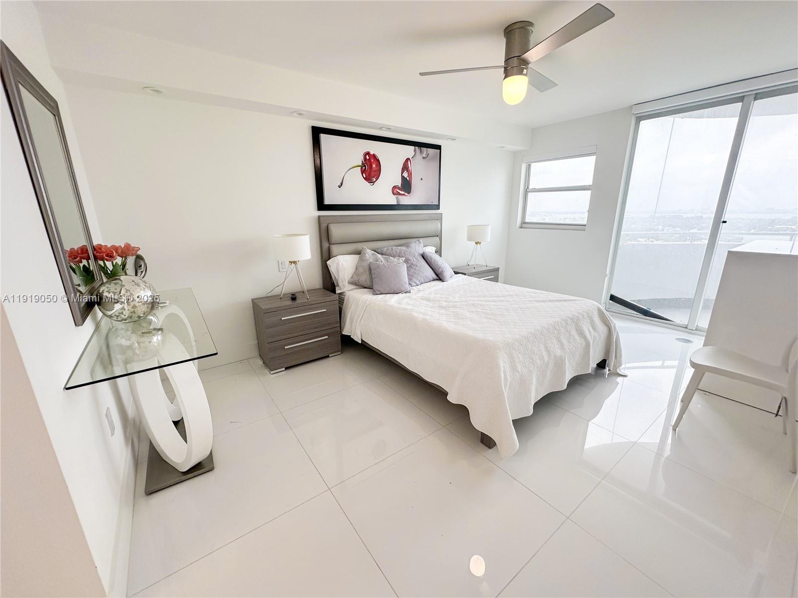 6301 Collins Avenue, Unit 2707 Miami Beach, FL 33141 - Photo 11 of 38 a bedroom with a bed and a painting on the wall