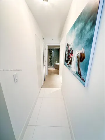 a hallway with painting and stairs