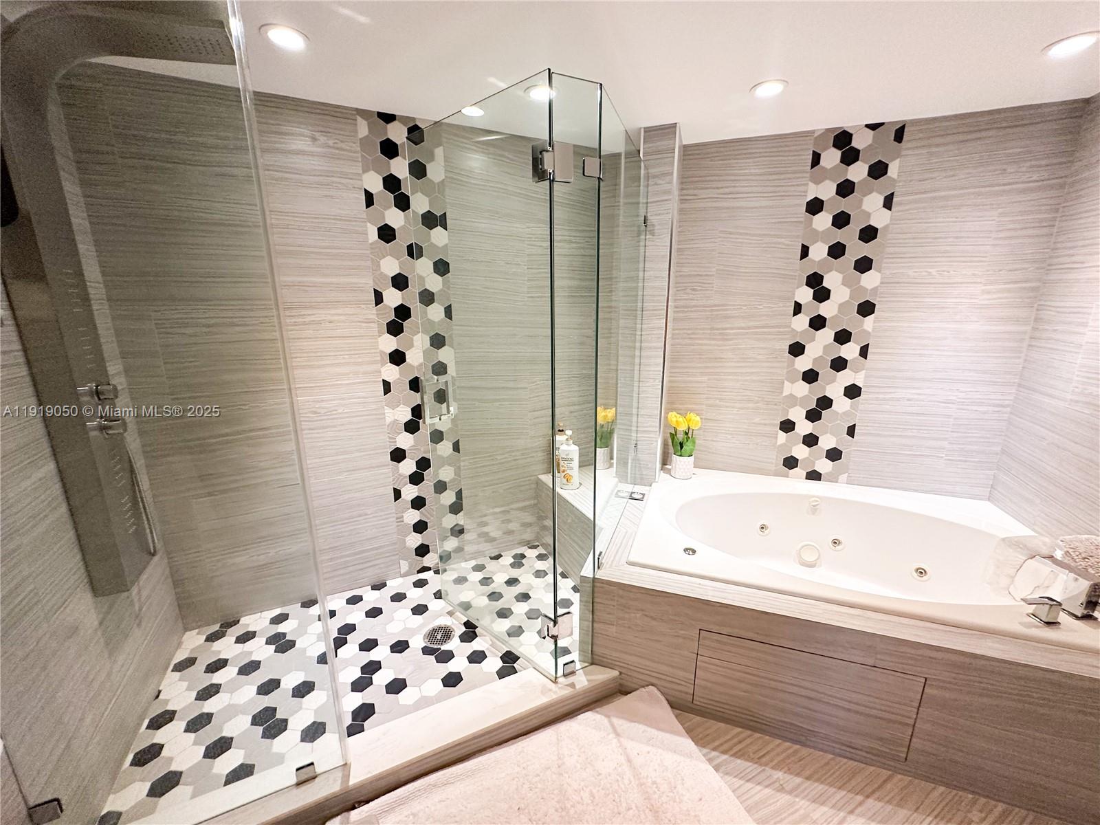 6301 Collins Avenue, Unit 2707 Miami Beach, FL 33141 - Photo 16 of 38 a bathroom with a bathtub and shower