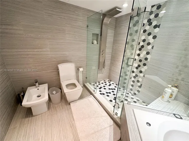 a bathroom with a bathtub and a shower