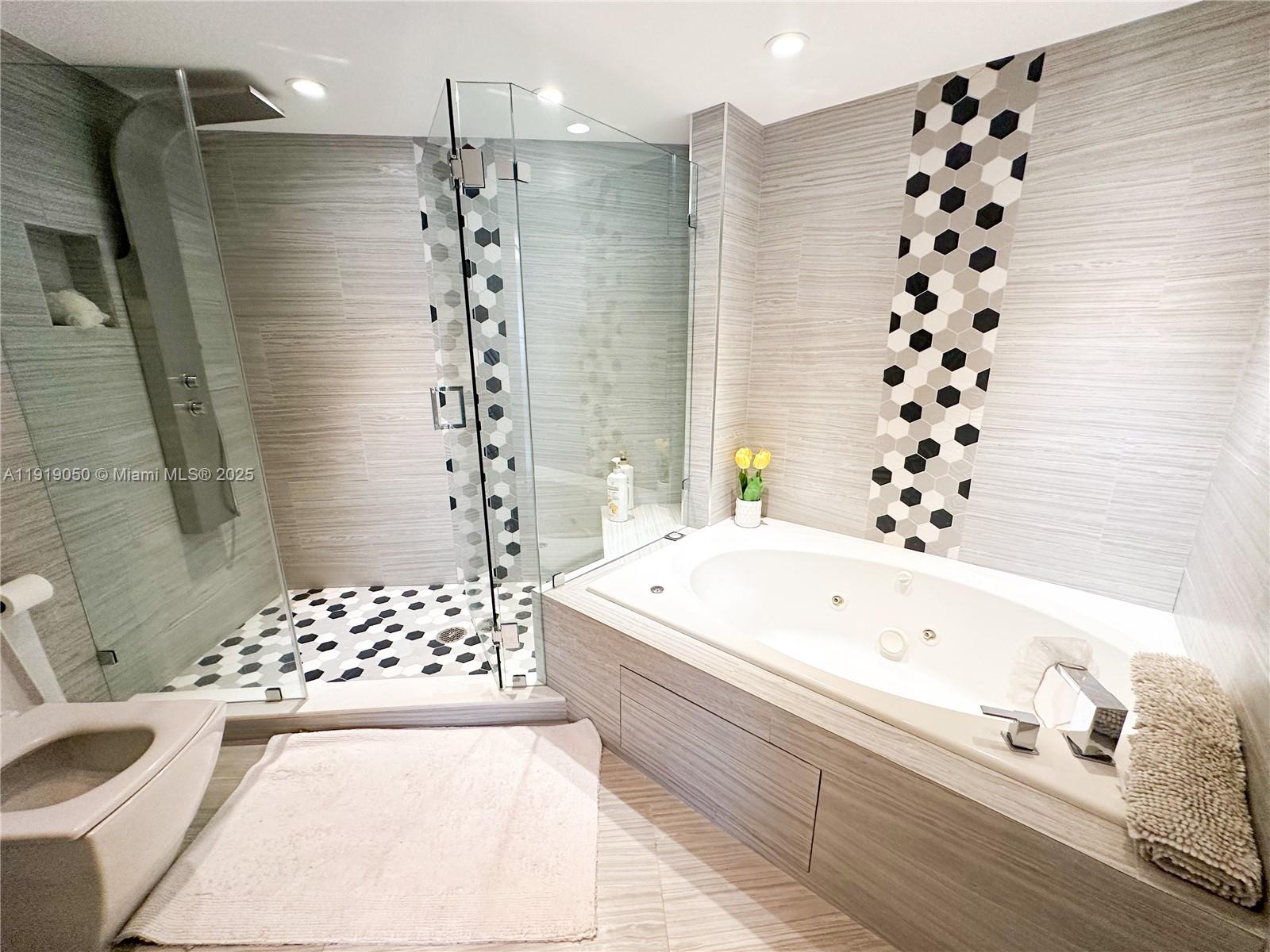 6301 Collins Avenue, Unit 2707 Miami Beach, FL 33141 - Photo 18 of 38 a bathroom with a bathtub and a shower