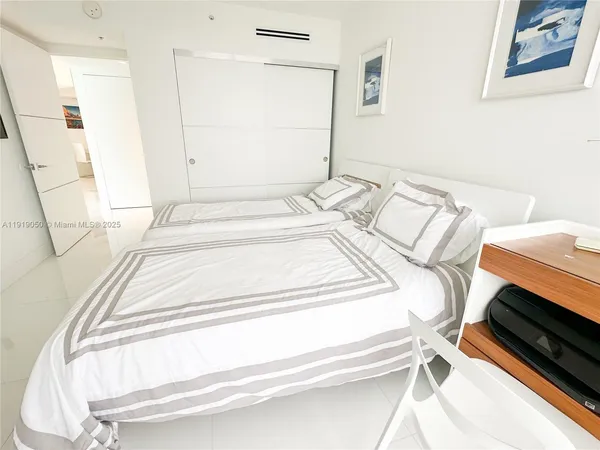 a bed sitting in a bedroom next to a window