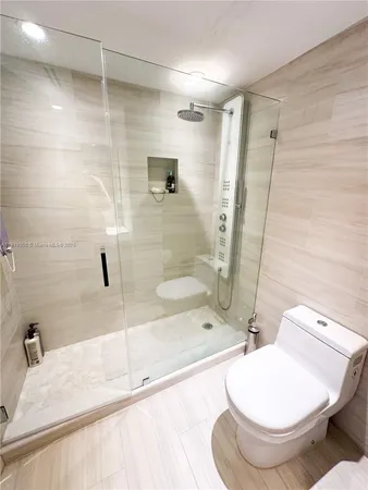 a living room with stainless steel appliances dining table chairs and a counter top