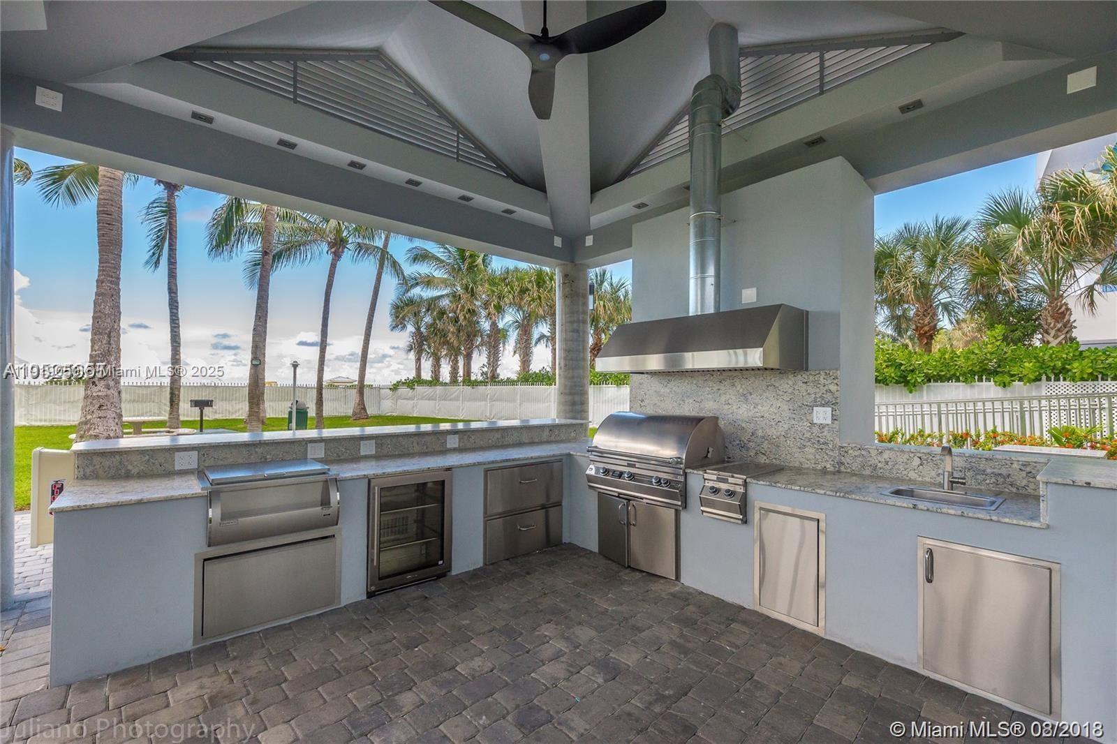 6301 Collins Avenue, Unit 2707 Miami Beach, FL 33141 - Photo 37 of 38 a kitchen with stainless steel appliances granite countertop a sink and a stove