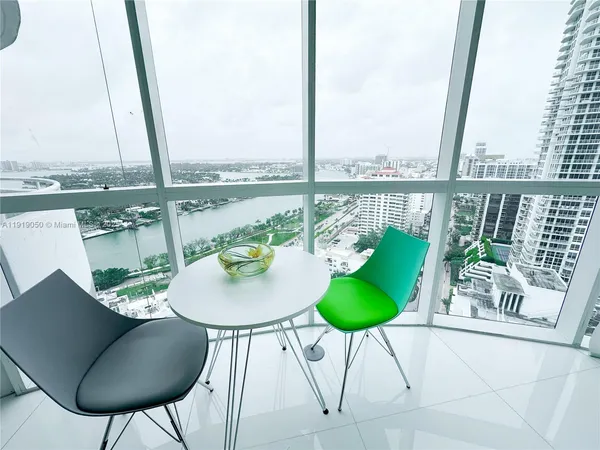 a view of a chairs and table in the balcony