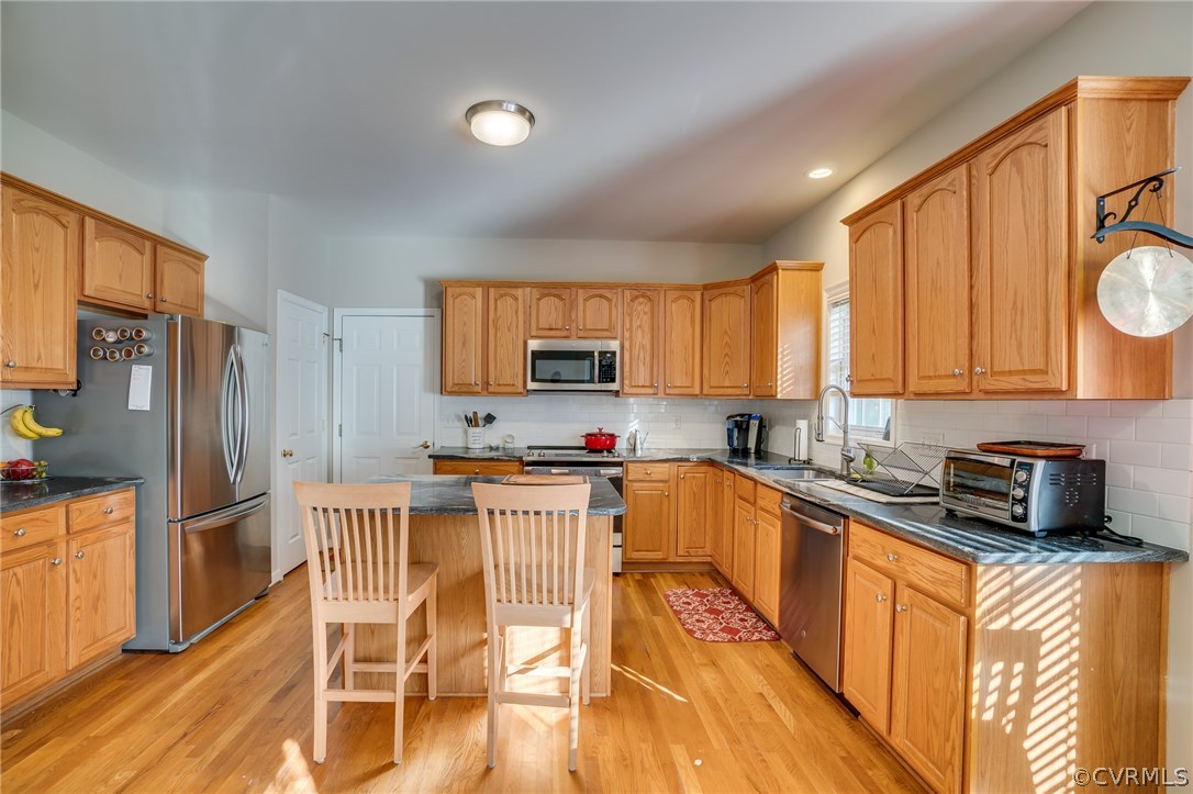 14721 Nash Road Chesterfield, VA 23838 - Photo 9 of 39 a kitchen with stainless steel appliances granite countertop a refrigerator a stove top oven a sink dishwasher and wooden cabinets with wooden floor