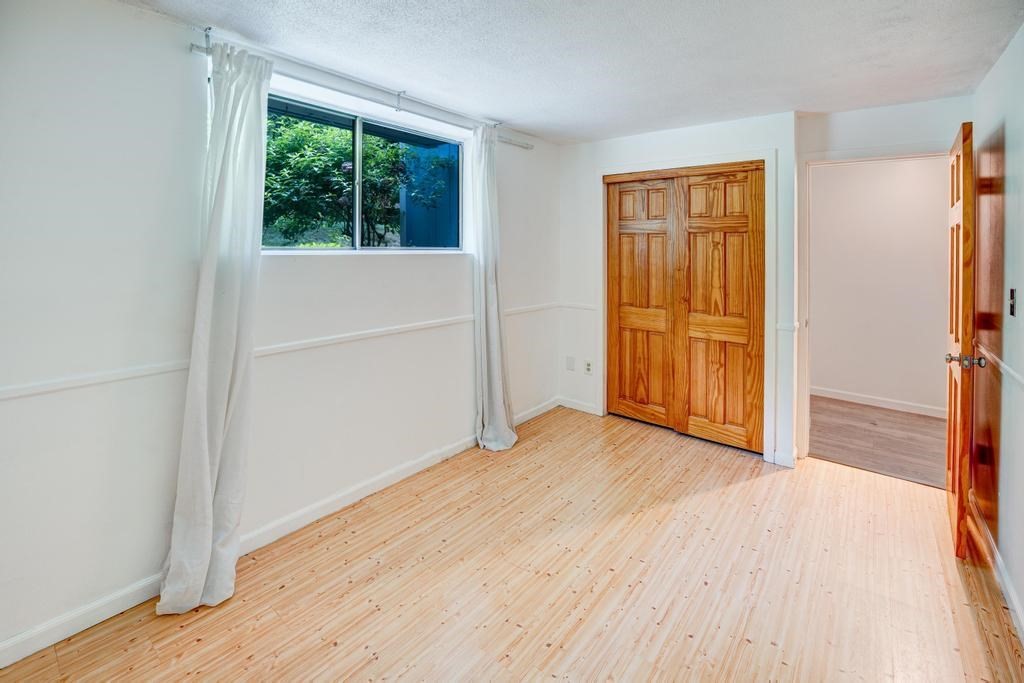 376 Great Road, Unit 15 Acton, MA 01720 - Photo 20 of 27 an empty room with wooden floor and windows
