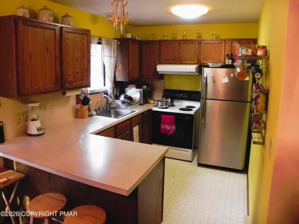 a kitchen with a sink a stove and a refrigerator