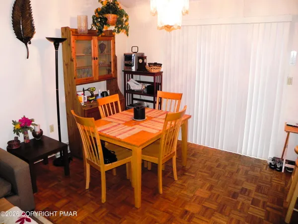 a dining room with furniture and a chandelier