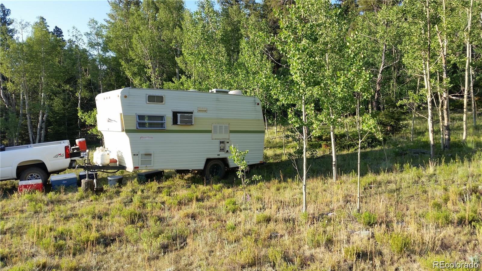 1681 Athapascan Road Hartsel, CO 80449 - Photo 6 of 9 a backyard of a house with lots of green space and fountain