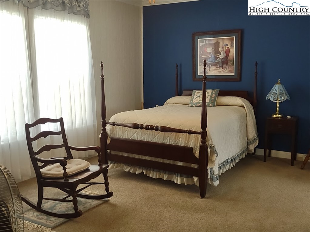 1407 Barrett Road Ennice, NC 28623 - Photo 15 of 24 a bedroom with a bed chair and window