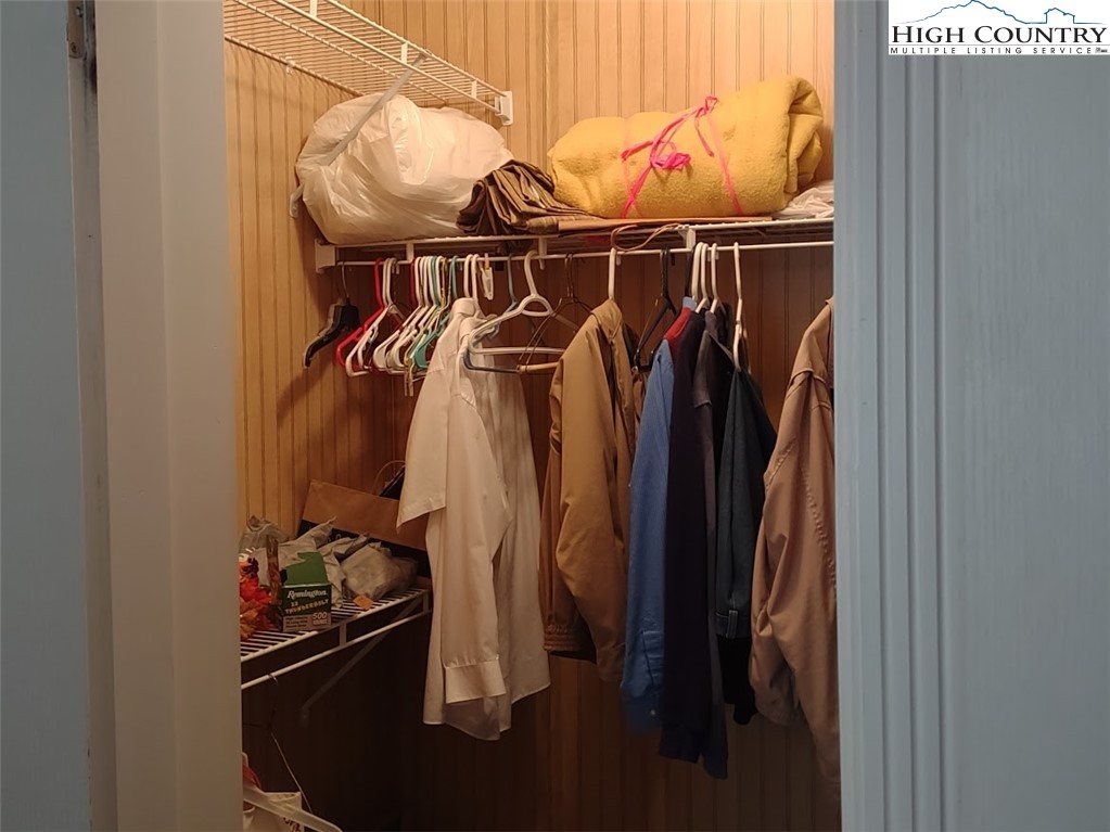 1407 Barrett Road Ennice, NC 28623 - Photo 16 of 24 a close view of walk in closet with clothes