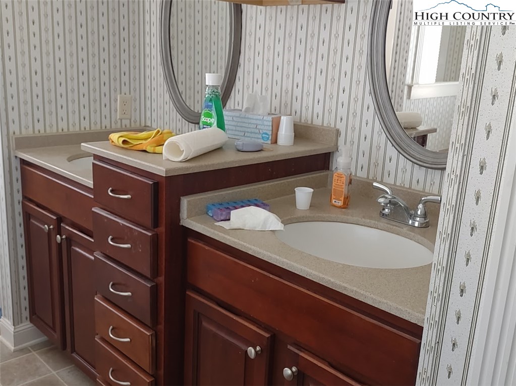1407 Barrett Road Ennice, NC 28623 - Photo 19 of 24 a bathroom with a sink a vanity and a mirror