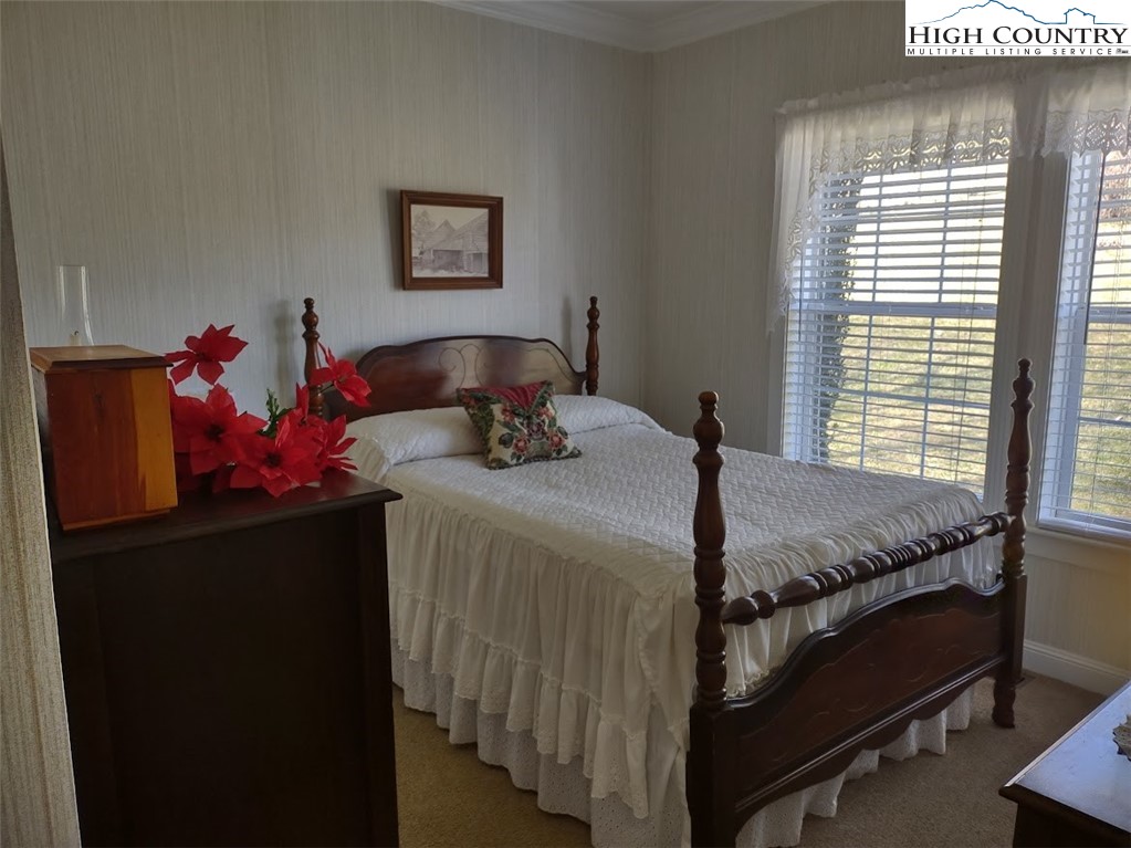 1407 Barrett Road Ennice, NC 28623 - Photo 20 of 24 a bedroom with a bed and a window