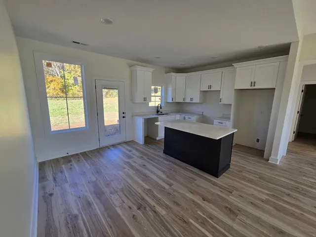 a large kitchen with wooden floors and wooden cabinets