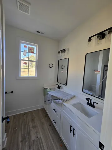 a bathroom with 2 sink and a mirror