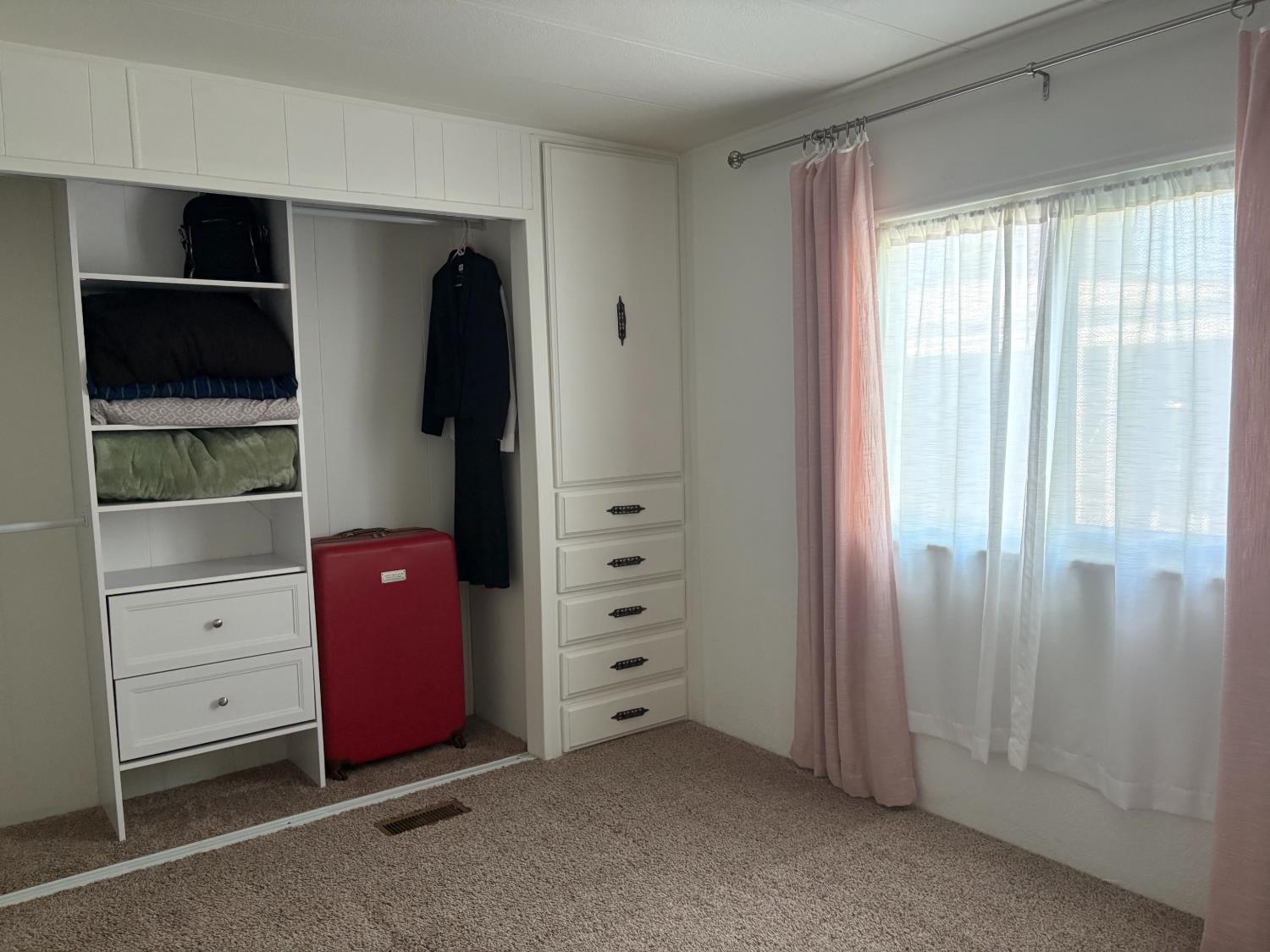 10035 Mills Station Road, Unit 153 Sacramento, CA 95827 - Photo 13 of 24 a view of an empty room with closet and windows