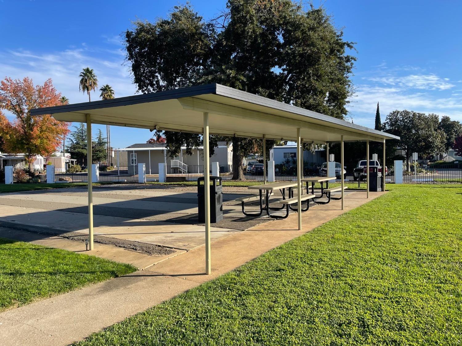 10035 Mills Station Road, Unit 153 Sacramento, CA 95827 - Photo 21 of 24 a view of a park with sitting area and slide