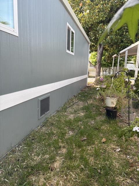 10035 Mills Station Road, Unit 153 Sacramento, CA 95827 - Photo 22 of 24 a backyard of a house with barbeque oven and outdoor seating