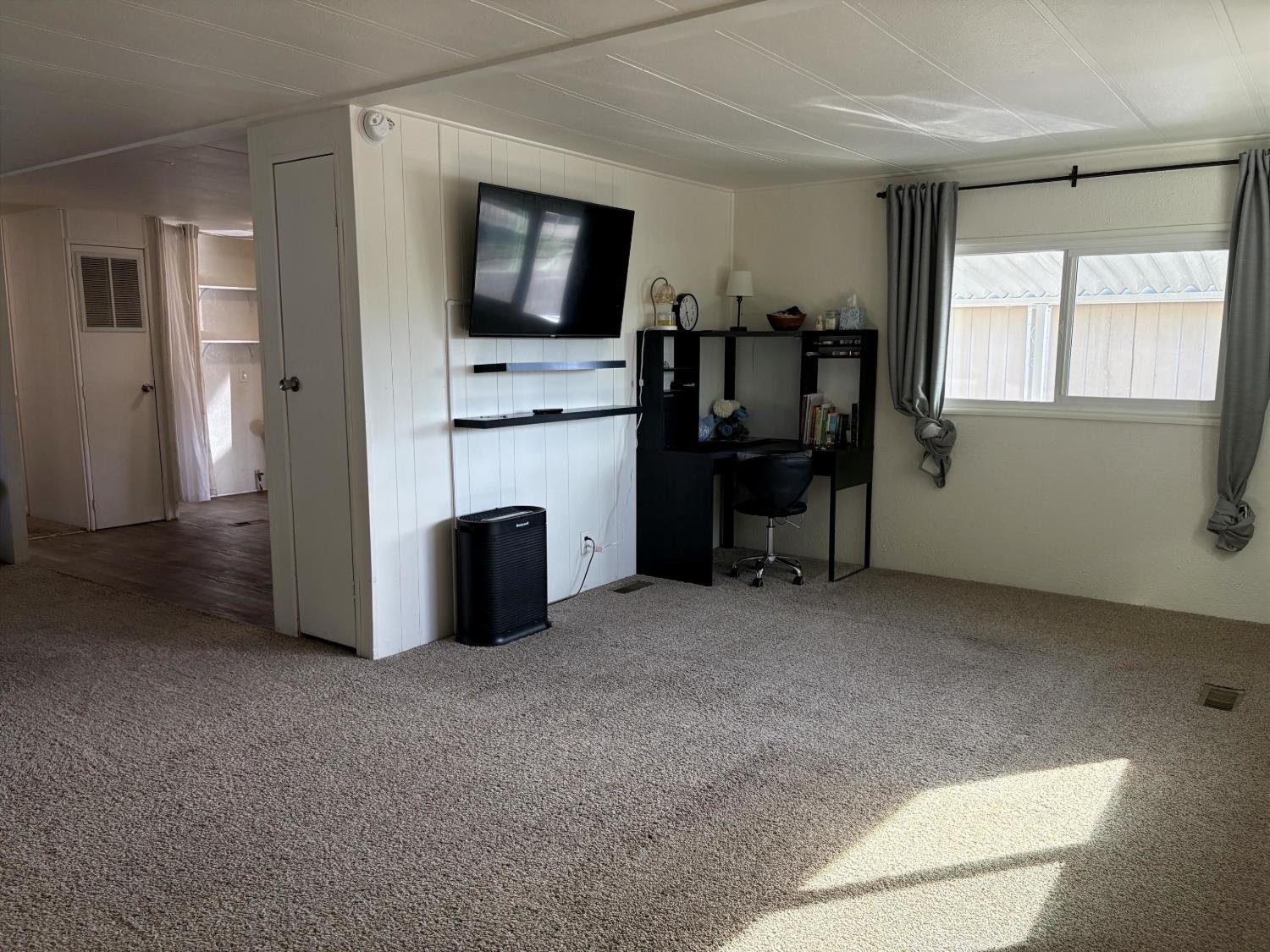 10035 Mills Station Road, Unit 153 Sacramento, CA 95827 - Photo 4 of 24 a view of a livingroom with furniture and a flat screen tv