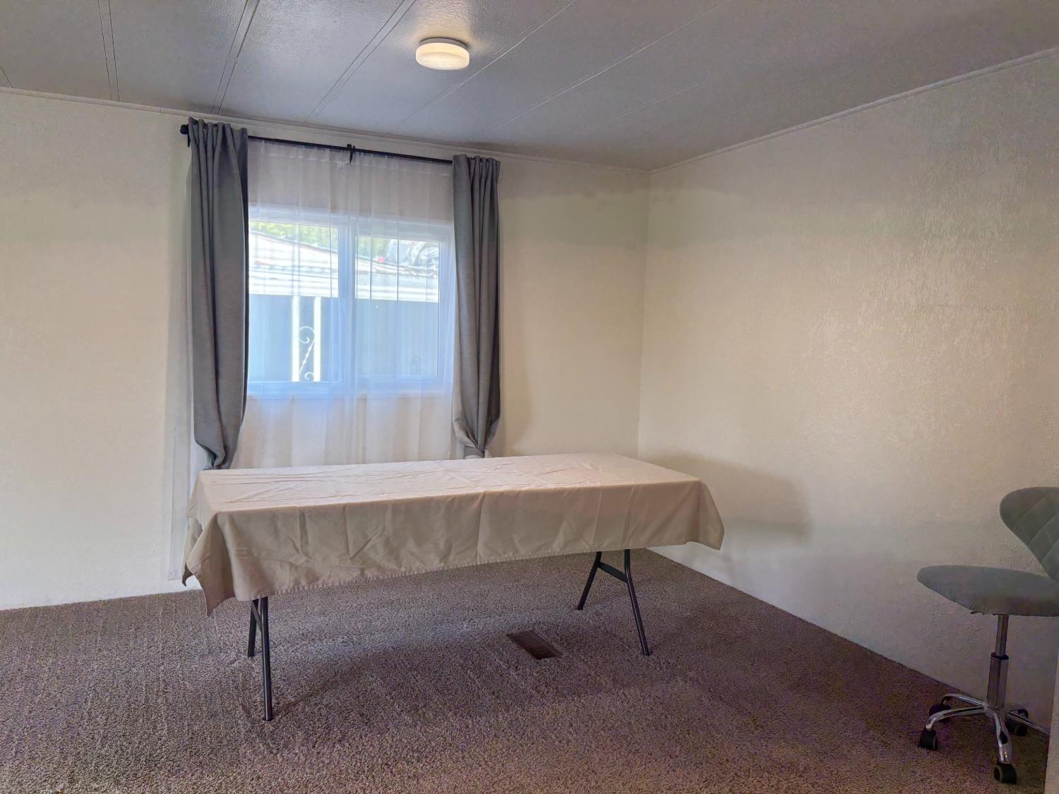10035 Mills Station Road, Unit 153 Sacramento, CA 95827 - Photo 5 of 24 a view of a room with a table and chairs