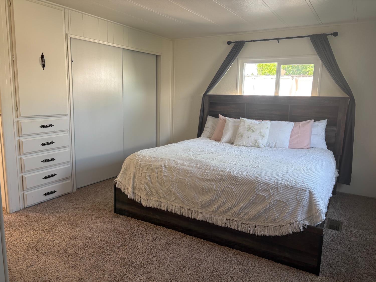 10035 Mills Station Road, Unit 153 Sacramento, CA 95827 - Photo 8 of 24 a bedroom with a bed and a window
