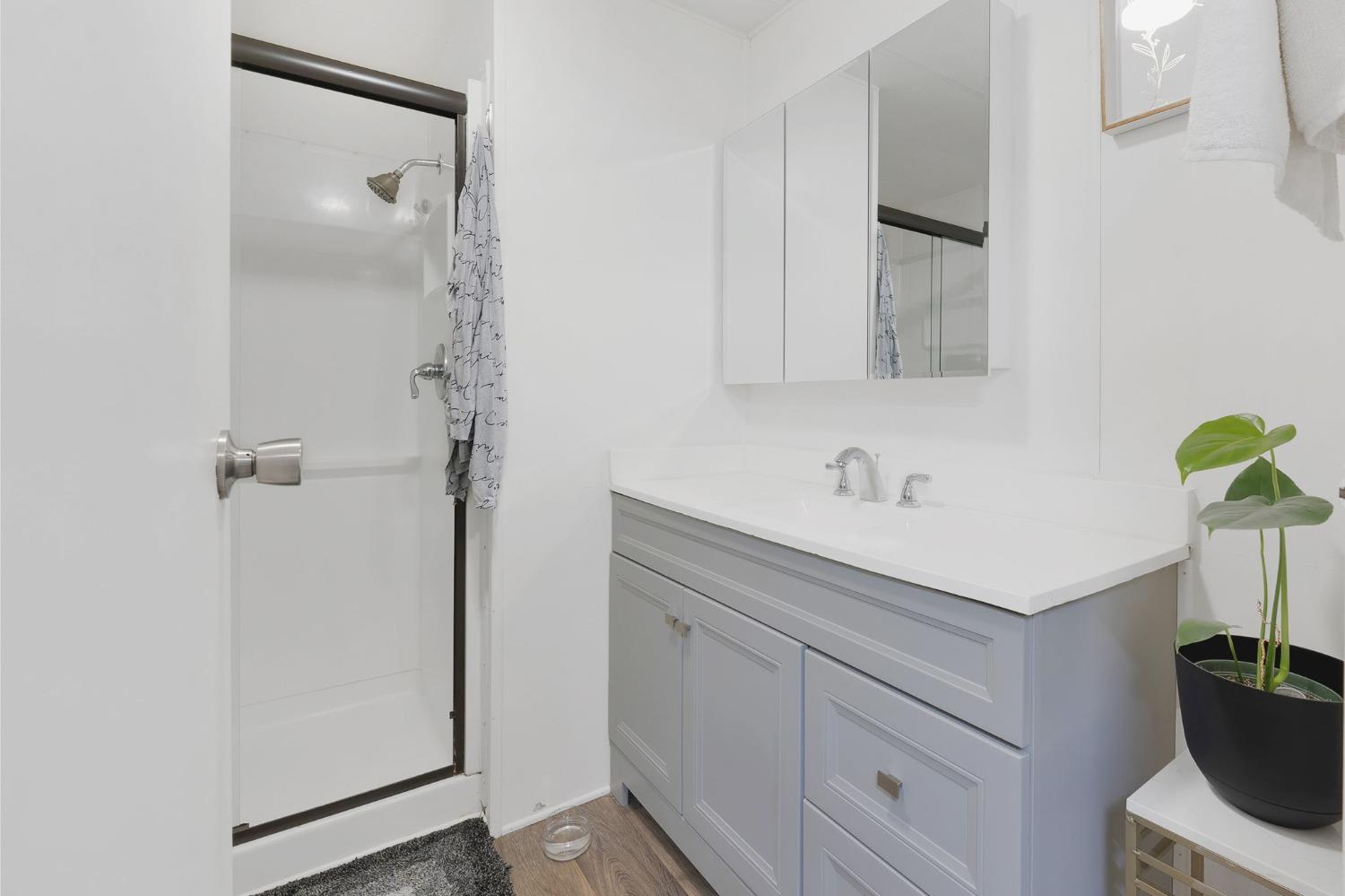 10035 Mills Station Road, Unit 153 Sacramento, CA 95827 - Photo 10 of 24 a bathroom with a shower sink and vanity