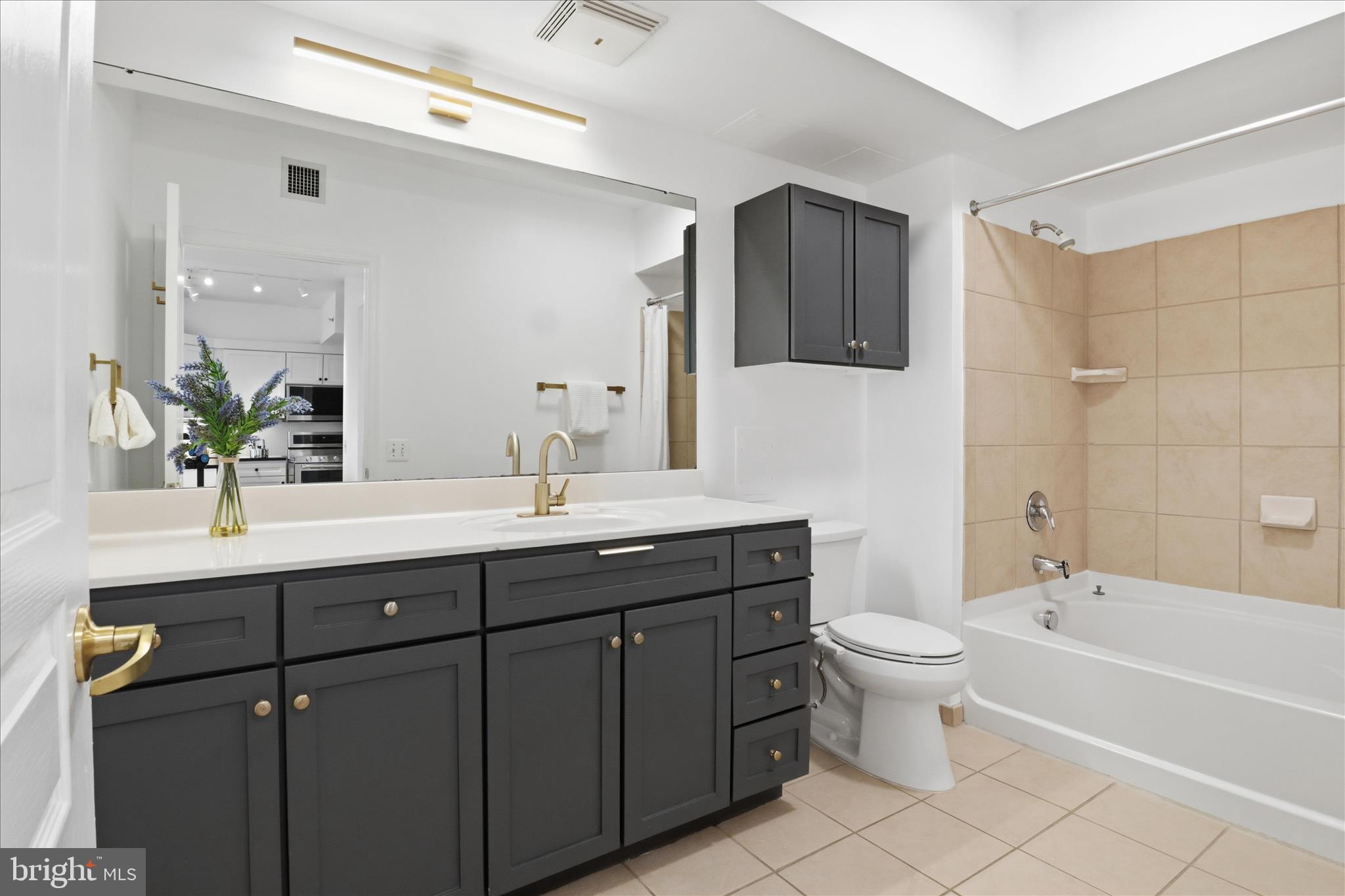 631 D Street Northwest, Unit 1227 Washington, DC 20004 - Photo 16 of 63 a bathroom with a double vanity sink toilet and shower