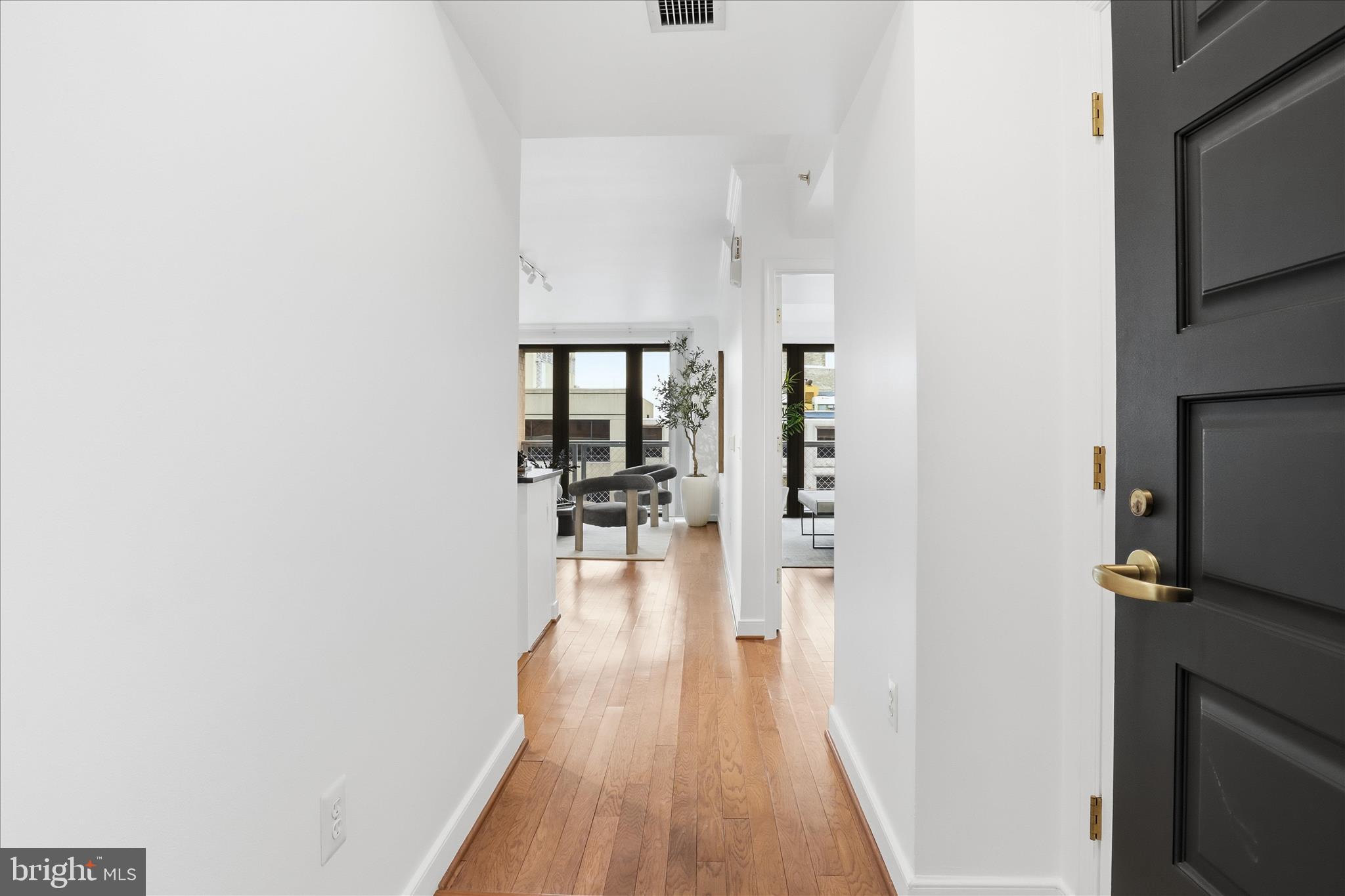 631 D Street Northwest, Unit 1227 Washington, DC 20004 - Photo 19 of 63 a hallway with wooden floor fireplace and living room